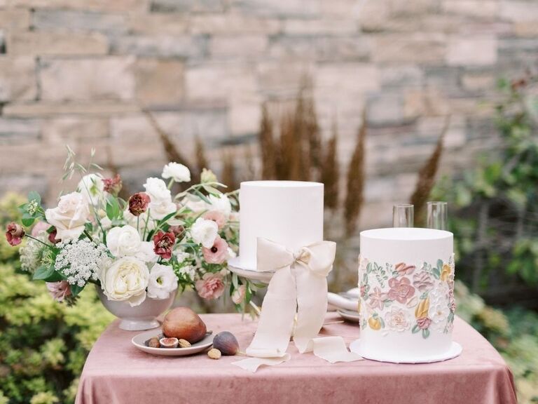 dessert table with two single-tier wedding cakes