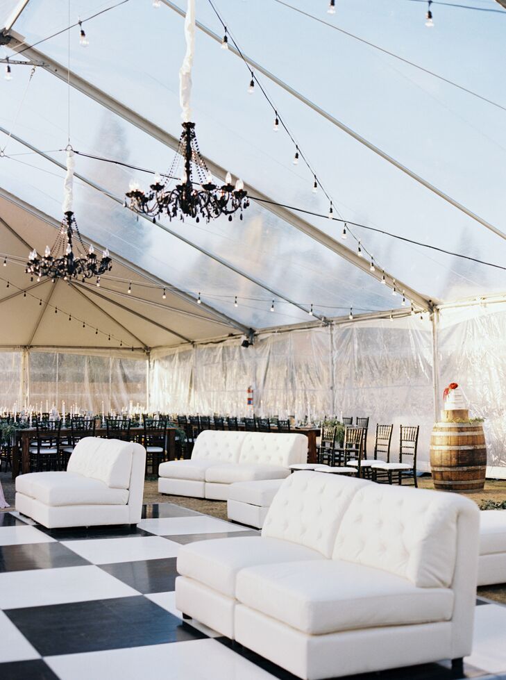 Inside the clear reception tent, chandeliers hung over a striking black-and-white-tiled dance floor, which was paired with chic white lounge furniture.