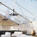 Inside the clear reception tent, chandeliers hung over a striking black-and-white-tiled dance floor, which was paired with chic white lounge furniture.