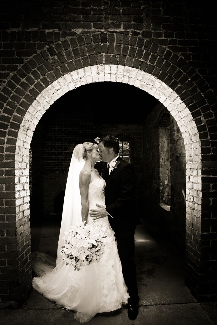 Married Couple Kissing Under Arch