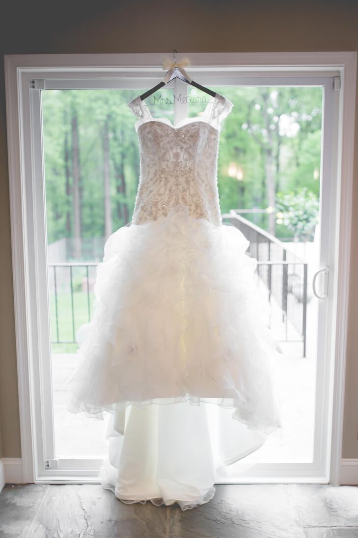 It took Mandy nearly a year to design her custom Kenneth Winston wedding dress. The dress featured a fitted lace bodice, cap sleeves and a ball-gown style.