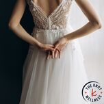 Bride clasping hands behind her back