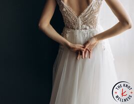 Bride clasping hands behind her back