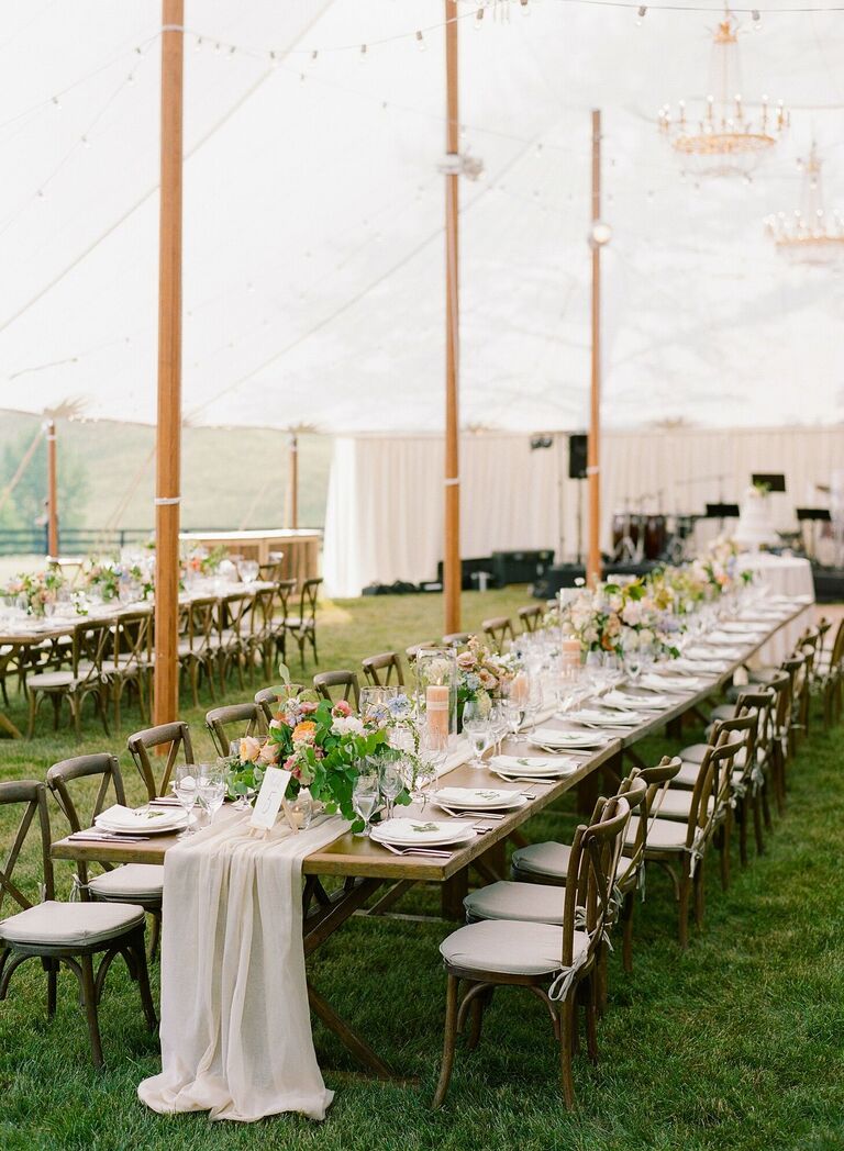 Rustic tented reception with farm tables