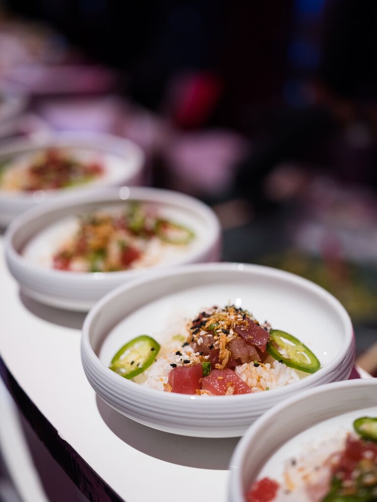 Line up of fresh poke bowls at a wedding reception.