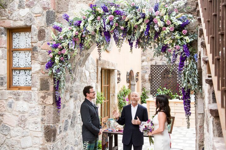 Ximena and Kent exchanged heartfelt vows under a lush floral wedding arch of purple delphinium, roses and greenery.
