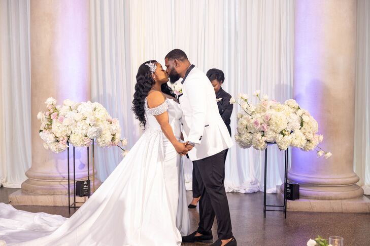 Bride in Off-the-Shoulder Gown Sharing First Kiss With Groom at Modern, Glam Altar