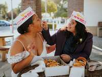 Brides eating In-N-Out fast food wedding takeout