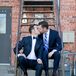 Two Groom's in Navy Suits Kiss Outside Alex Johnson Hotel