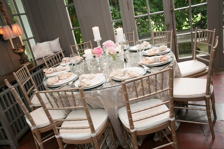 White candles and small pink floral arrangements added to the soft, romantic atmosphere at the reception.
