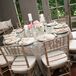 White candles and small pink floral arrangements added to the soft, romantic atmosphere at the reception.