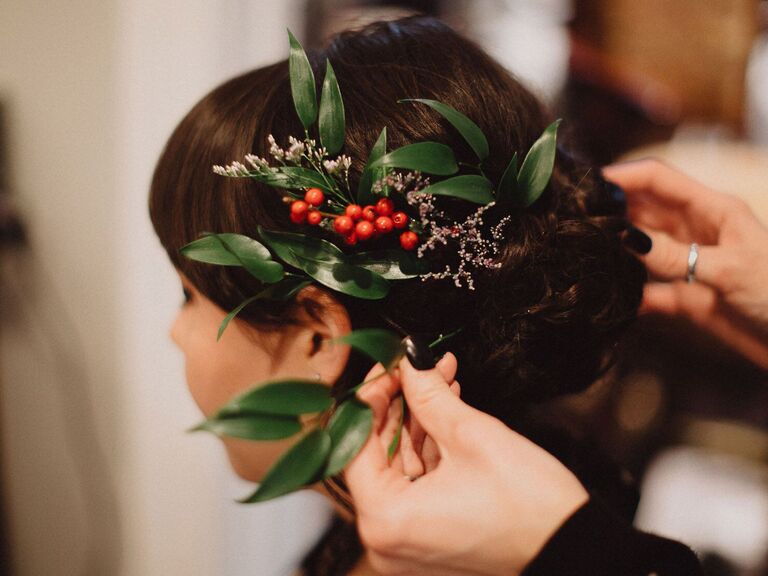 wedding hair flowers winterberry and greens atop low bun