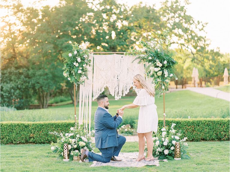 couple proposal in front of wedding altar