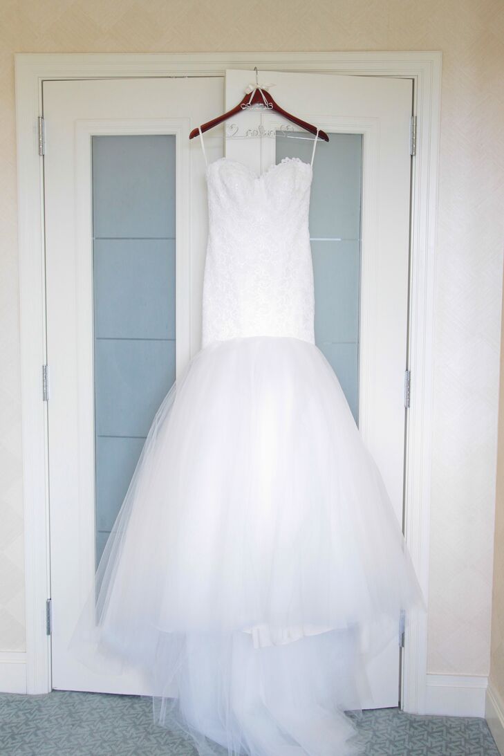 "I knew I wanted a glamorous type of dress, but I didn't want it too flashy," Laura says. "I tried on every cut and style imaginable just in case, since I'm known to be pretty indecisive.  I ended up falling in love with a Romona Keveza drop waist mermaid lace gown. It had a gorgeous sweetheart neckline, shimmery bodice and tulle bottom."