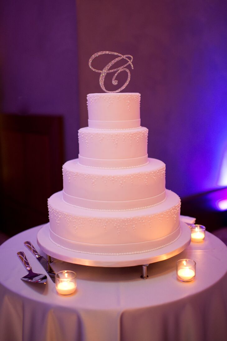 Laura and Joseph's cake pulled out all the glamorous and delicious stops, from a glittering monogrammed cake topper to two alternating layers of dark chocolate with caramel fudge filling and classic white cake with chocolate mousse filling.