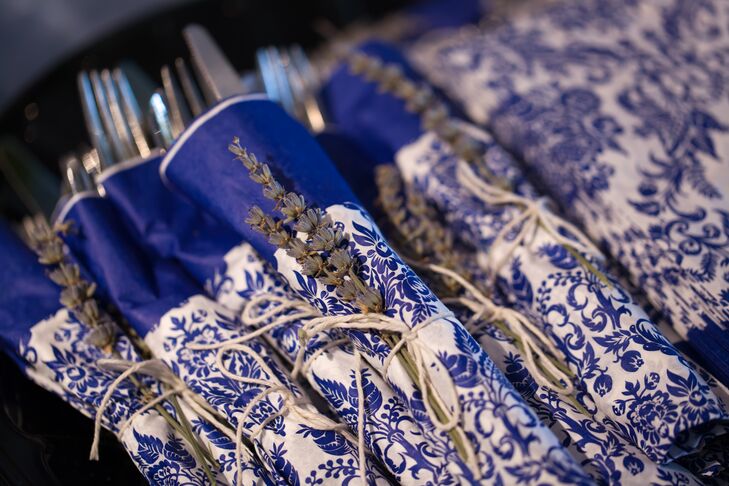 Silverware sets placed on the reception dining tables were wrapped in white and blue paisley napkins. The napkins were tied with thin yarn, holding in place a dried piece of lavender that gave off a boho look.