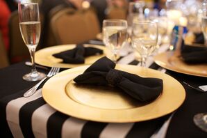 Black Bow and Gold Plate Decor with Striped Table Runner