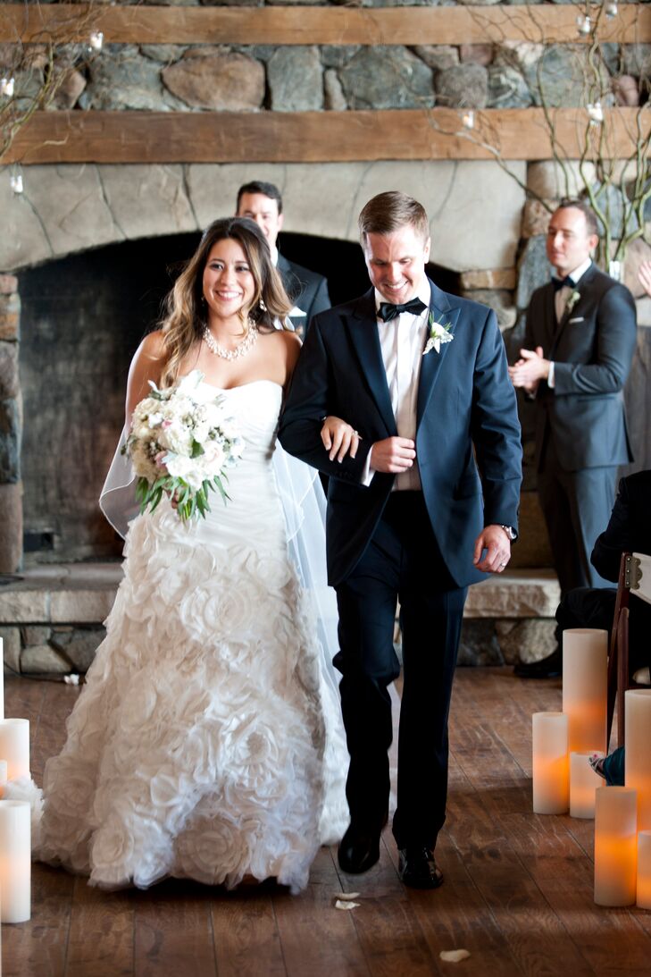 Because the couple knew they would be out and about in the snow, their attire for the wedding wasn't their biggest concern. However, Jemma found a striking strapless gown in a dropped waist silhouette with a floral tulle skirt at David's Bridal at a great price.