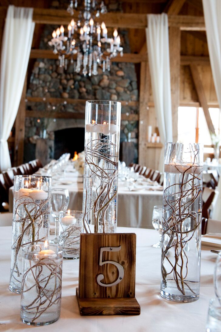 Wispy willow branches gave the floating candle centerpieces a whimsical wintery look.