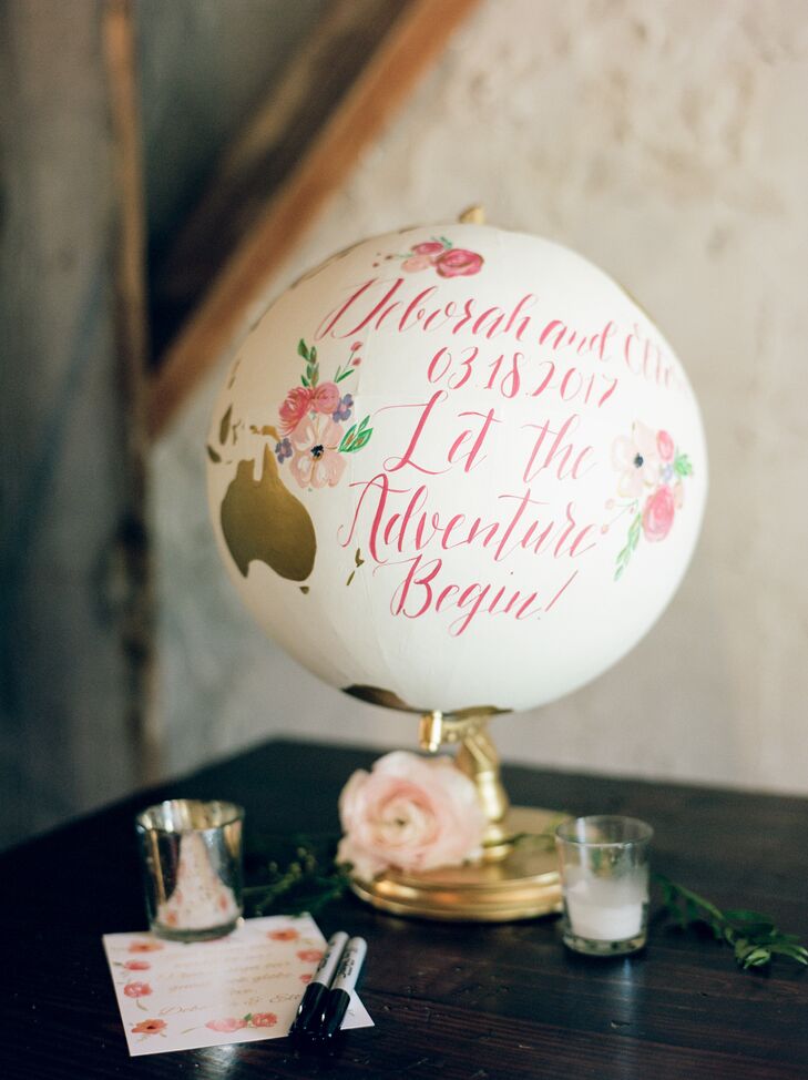 A handcrafted globe calligraphed with Deborah and Elton's wedding date sat at the guest book and gift table for a personal touch.