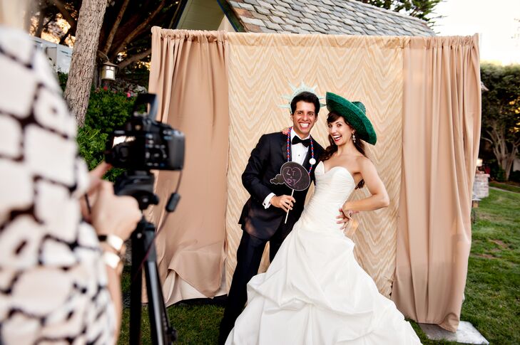 The bride and groom provided an open-air photo booth for their oceanside reception. Guests were allowed to keep one copy and asked to sign another for the bride and groom to keep.