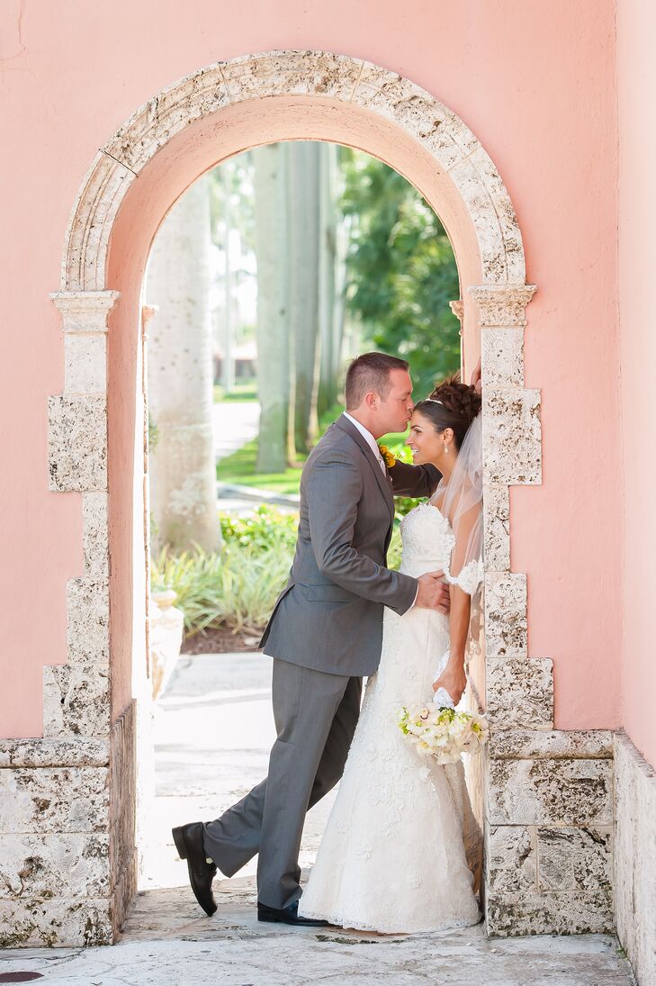 Terri chose a strapless ivory lace Justin Alexander signature wedding dress and elbow-length veil for her wedding day. Matt complemented her in a gray tuxedo, white shirt and white tie.