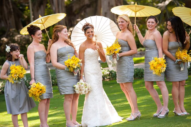 Each of Terri’s bridesmaids paired her silver, cocktail-length, strapless Monique Lhuillier dress with a bouquet of yellow orchids, yellow ranunculus, yellow stock flowers and dusty miller.