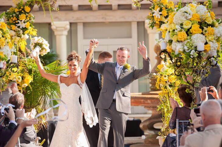 Terri and Matt had a unity lantern tradition incorporated into their ceremony. They exchanged vows under a bright dragon wood arch adorned with yellow roses, white hydrangeas, white stargazer lilies, yellow garden roses and grape vines. It was arranged by Daniel Events.