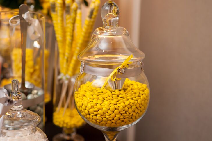 Terri and her mother designed a yellow and silver candy bar for the reception. Guests were welcome to take home some confections as well as a stainless steel key chains with "live, love, laugh" engraved upon them as wedding favors.