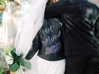 wedding couple bride wearing leather jacket with just married on the back