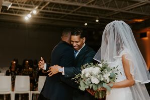 Groom and Father of the Bride Share Hug During Ceremony