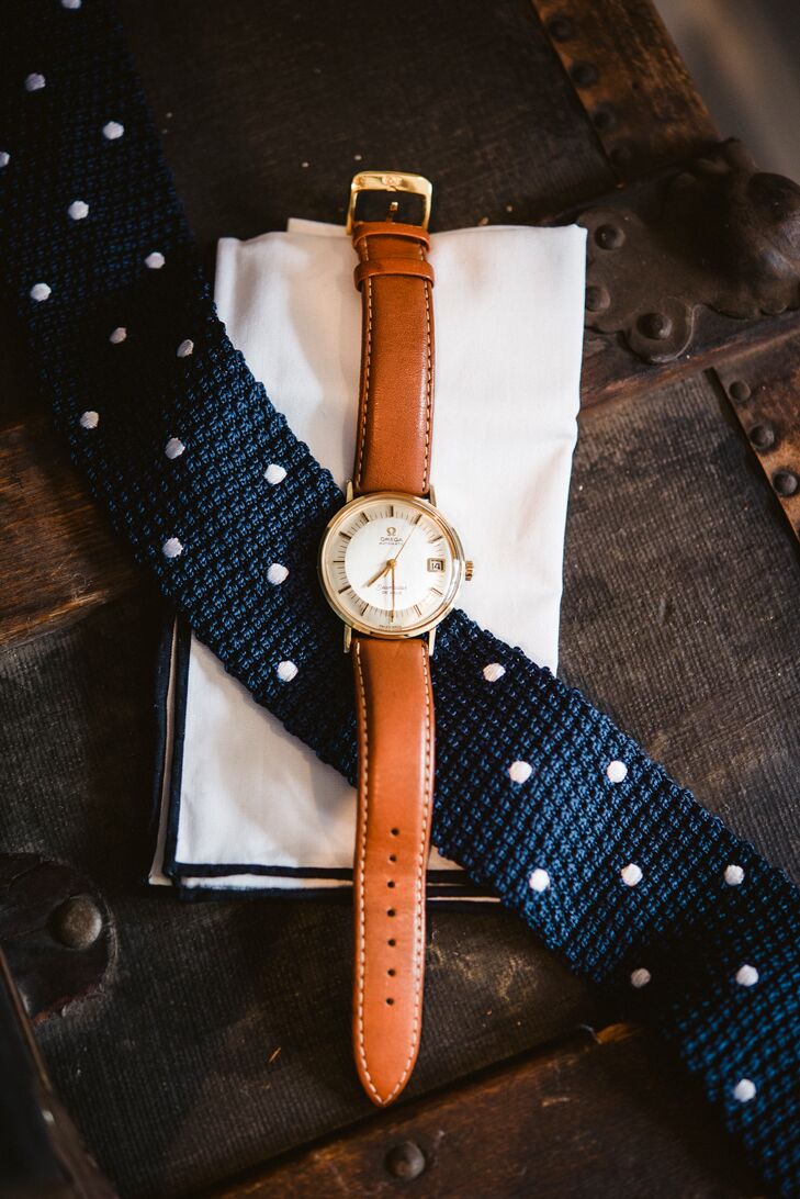 Matt accessorized his custom navy suit with a knitted polka-dot tie from the Tie Bar, his  father's watch, a crisp white pocket square, and a pair of baby blue socks.