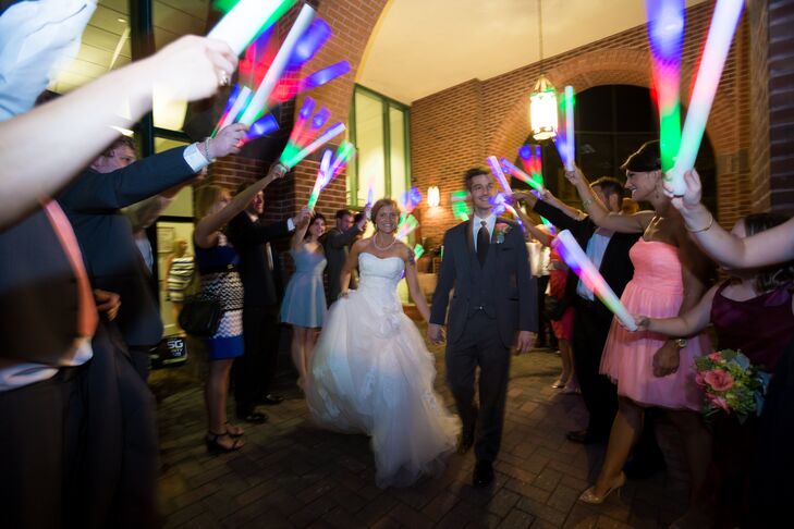 Instead of a traditional sparkler send off, guests waved colorful glow sticks as the couple made their exit from the reception.