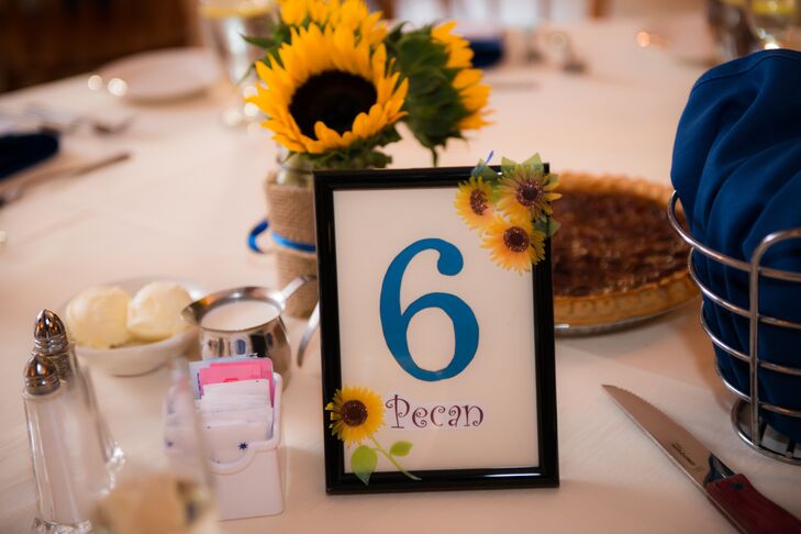 Kristin and Jon titled the table numbers corresponding with the assortment of pies on the dessert table.