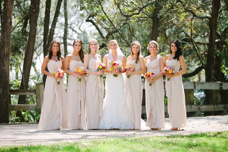 The bridesmaids wore neutral floor-length dresses with sweetheart necklines from Belles N Beaus. Each complemented the gown with teardrop earrings and a simple necklace.