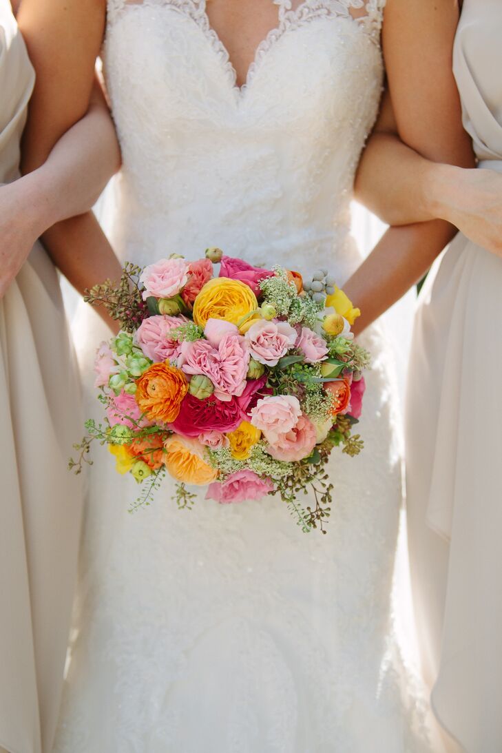 Arranged by Missy Gunnels Flowers, Katelyn carried a bouquet of orange, yellow and pink garden roses, pink peonies, orange ranunculus, silver brunia and greenery.