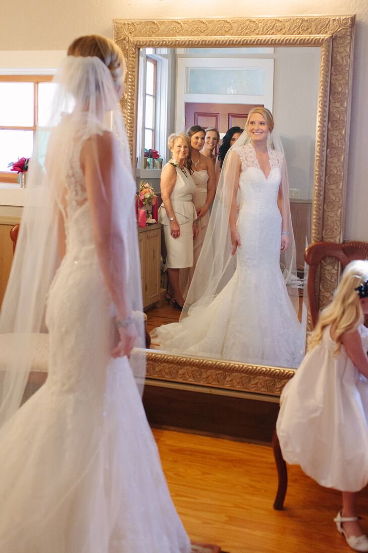 Katelyn chose an all-lace sleeveless mermaid wedding dress by Allure Bridal. She complemented it with a floor-length tulle veil, braided undo and simple jewelry.