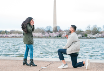 Man proposing to woman in front of water and washington monument in Washington DC