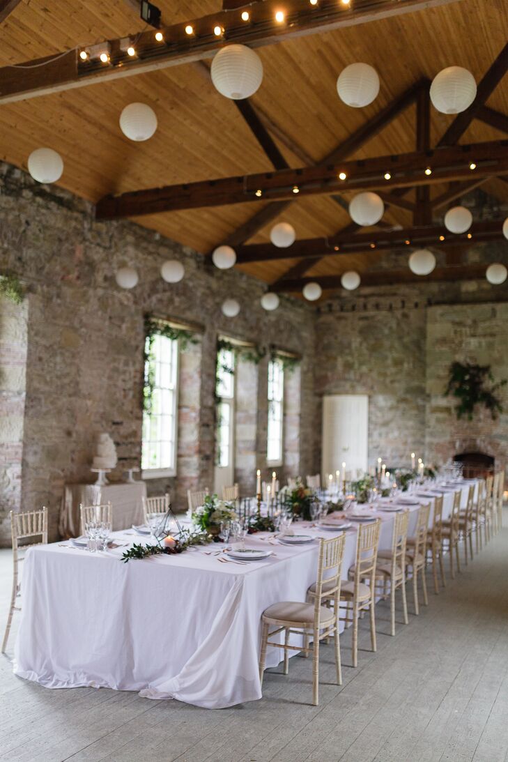 The newlyweds and their guests headed indoors for the reception, sitting down to dinner in Borris House’s historic ballroom. Exposed wooden beams, natural wood floors and stone walls gave the celebration a cozy and inviting vibe. Everyone gathered around a long table to enjoy a family-style meal by candlelight, further heightening the evening’s sense of intimacy.