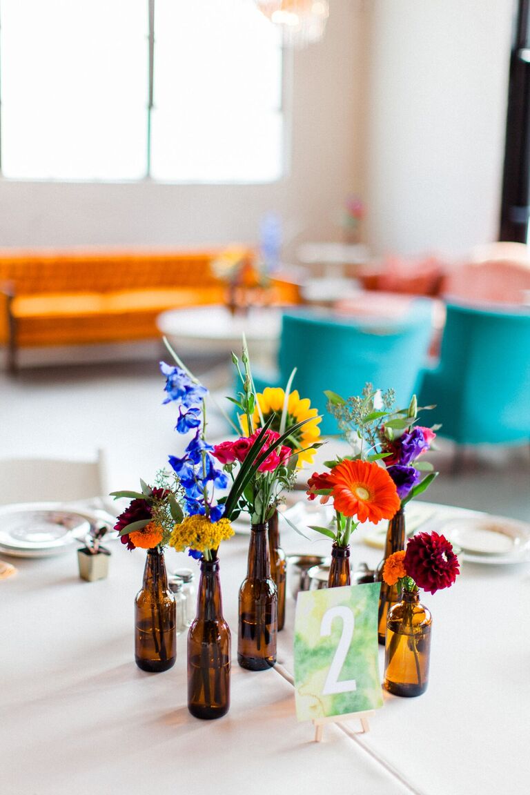 Cluster centerpiece with wildflowers in brown glass bottles