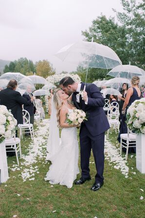 Couple Shares Kiss Under Umbrella During Rainy Recessional