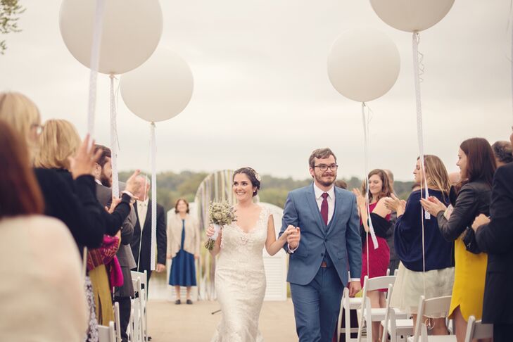 After searching through Pinterest, Erin and Cory picked out a festive suit for his wedding day look.  He wore a "postman" blue suit and a burgundy tie with a subtle, matching blue pattern. His groomsmen, however,  stood out in navy blue suits and pale green ties.