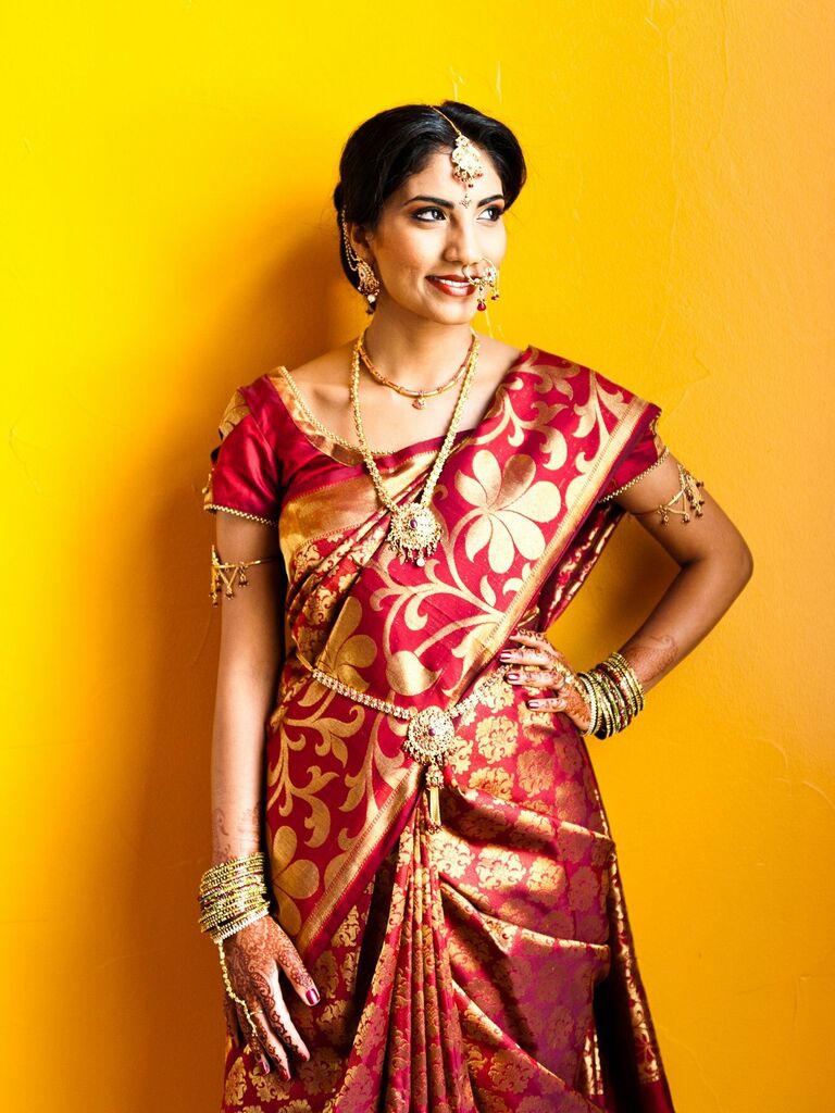 Bride wearing a traditional red and gold sari.