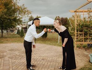Bride and Groom in Formal Attire Taking Shots at Backyard Wedding