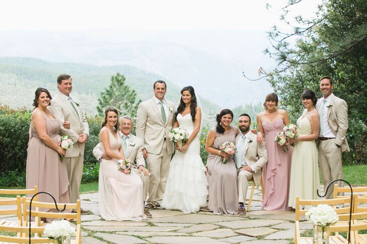 Raquel and Sean stood together with their wedding party, with bridesmaids dressed in pastel-colored dresses and groomsmen wearing tan suits with sage green ties. "I chose tan linen suits for the men with mint green ties," Raquel says. "The bridesmaids picked their own dresses in muted pastels of cream, pink and lavender."