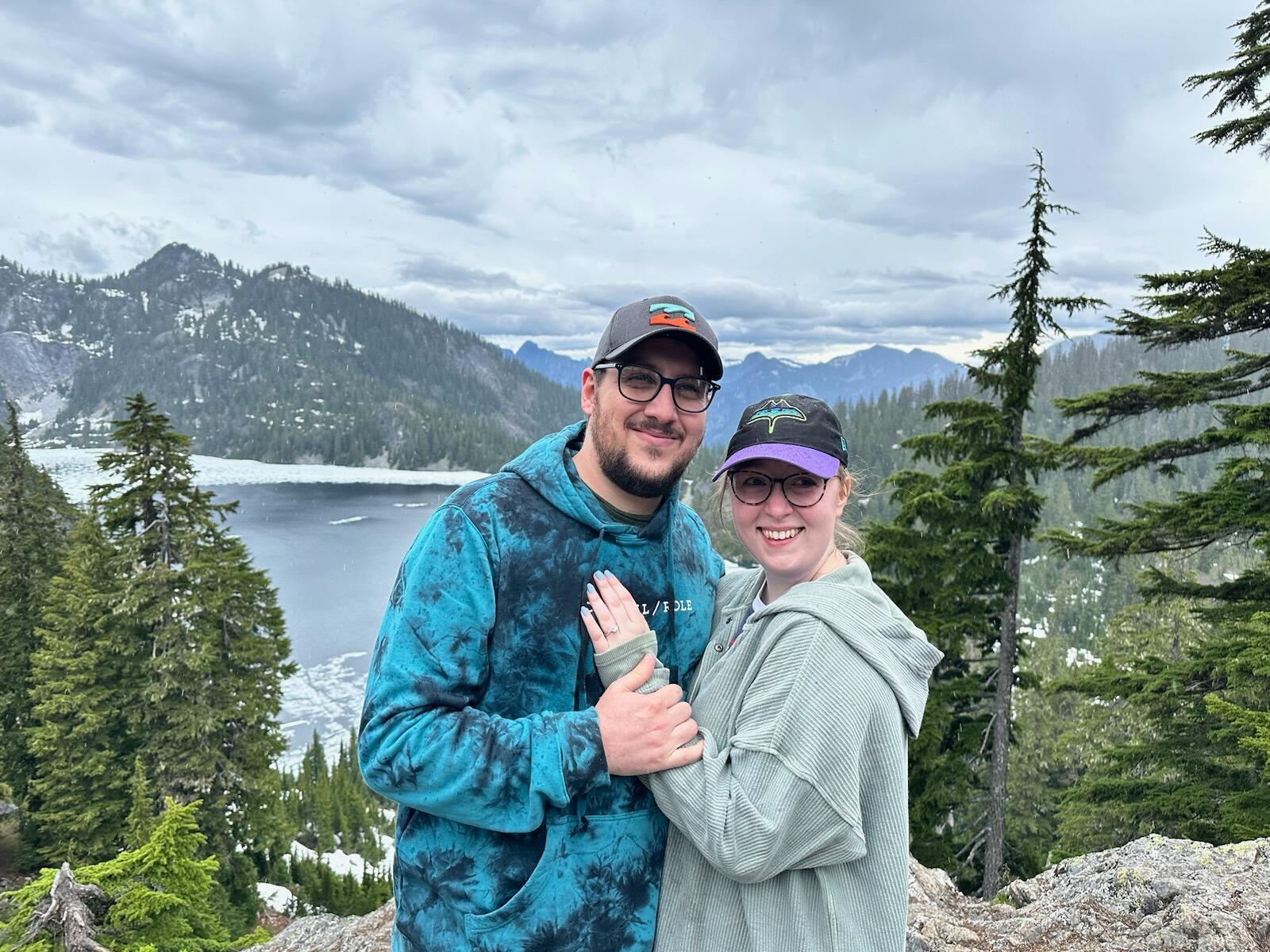 On what was believed to be a "nature walk," Chris and Haley embarked, along with Chris' brother, Glenn, and sister-in-law, Brittany, on a hike to Snow Lake in the Cascades of Washington. The group trekked through rocky, evergreen-lined paths and across streams formed by waterfalls to reach the summit of Mt. Baker. After what amounted to an extremely challenging hike (for two Florida-dwellers), the group soaked in the spectacular view and misting rain at the summit. After gathering his breath, Chris went down on one knee to ask Haley to become his lifelong partner in all future adventures through life. Needless to say, she said "yes!"