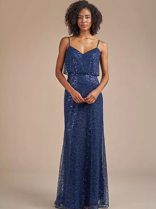 A model wears a spaghetti strap sparkly bridesmaid gown.