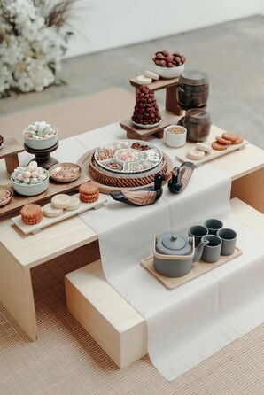 Small Cakes and Sweets on Low Table Setup for Traditional Korean Paebaek Tea Cerermony