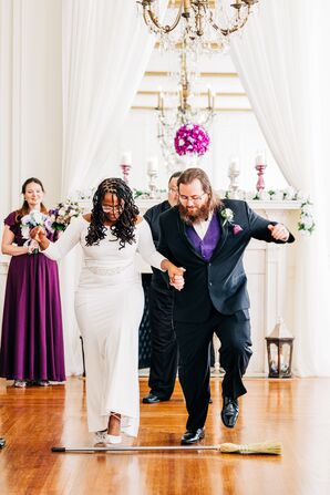 Bride and Groom Jumping the Broom at The Hotel Concord in North Carolina