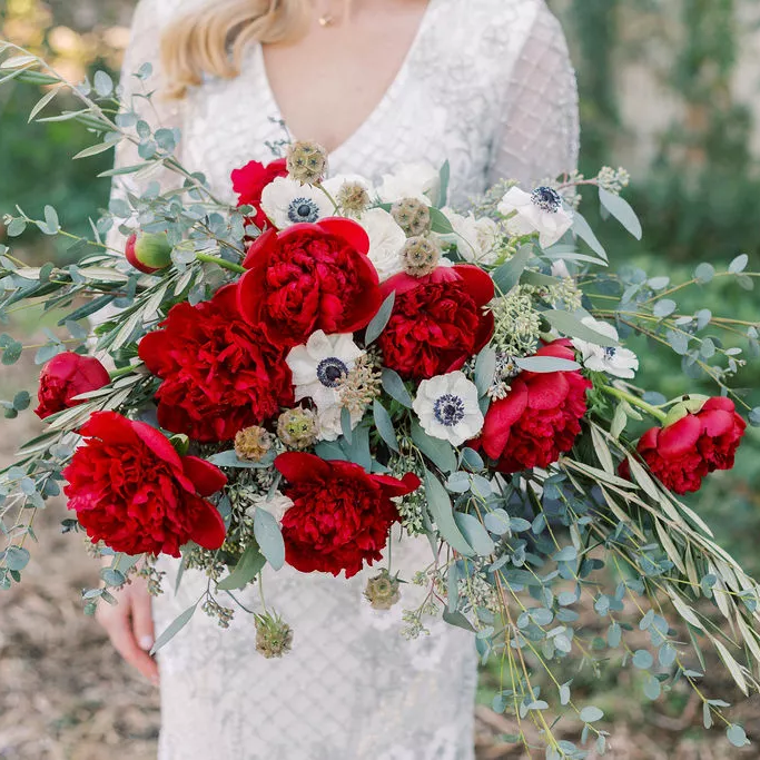 Vibrant red peony bridal bouquet with eucalyptus